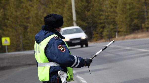 Сотрудник ДПС останавливает автомобиль на одном из участков федеральной автодороги А-350 Чита - Забайкальск