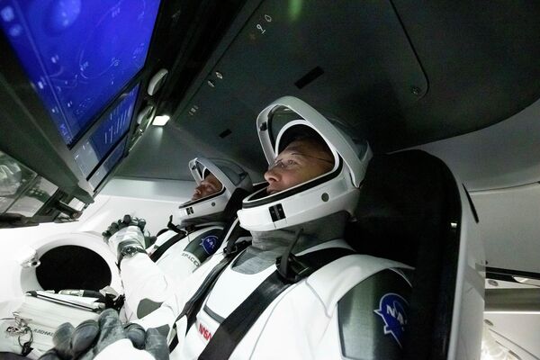 Астронавты Дуглас Херли и Роберт Бенкен в космическом корабле Crew Dragon Астронавты Дуглас Херли и Роберт Бенкен в космическом корабле Crew Dragon