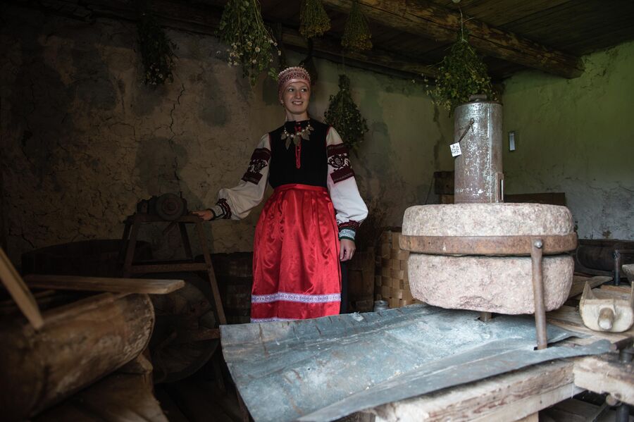 Сотрудница музея-усадьбы народа сето в деревне Сигово Псковской области демонстрирует экспонаты музея