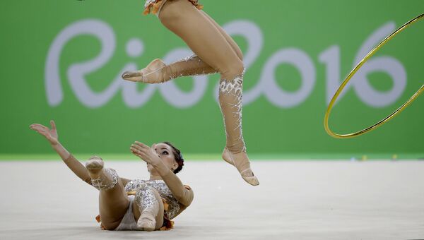 Спортсменки сборной России выступают в финале групповых соревнований по художественной гимнастике на XXXI летних Олимпийских играх. Архивное фото Спортсменки сборной России выступают в финале групповых соревнований по художественной гимнастике на XXXI летних Олимпийских играх. Архивное фото
