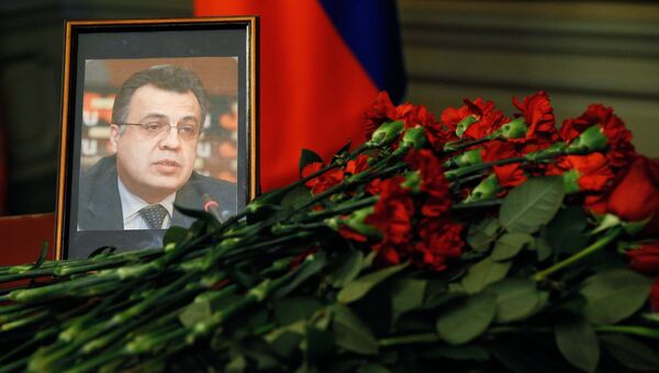 Цветы у портрета посла России в Турции Андрея Карлова. Архивное фото Цветы у портрета посла России в Турции Андрея Карлова. Архивное фото