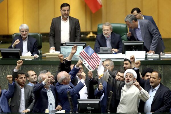 Иранские парламентарии поджигают флаг США и копию договора по Совместному всеобъемлющему плану действий (СВПД) по иранской ядерной программе в Тегеране Иранские парламентарии поджигают флаг США и копию договора по Совместному всеобъемлющему плану действий (СВПД) по иранской ядерной программе в Тегеране