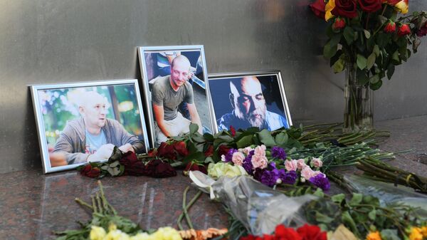 Цветы у фотографий погибших в Центральноафриканской Республике российских журналистов возле Дома журналистов в Москве Цветы у фотографий погибших в Центральноафриканской Республике российских журналистов возле Дома журналистов в Москве