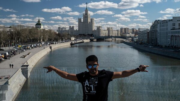 Мужчина фотографируется на Парящем мосту в парке Зарядье в Москве Мужчина фотографируется на Парящем мосту в парке Зарядье в Москве
