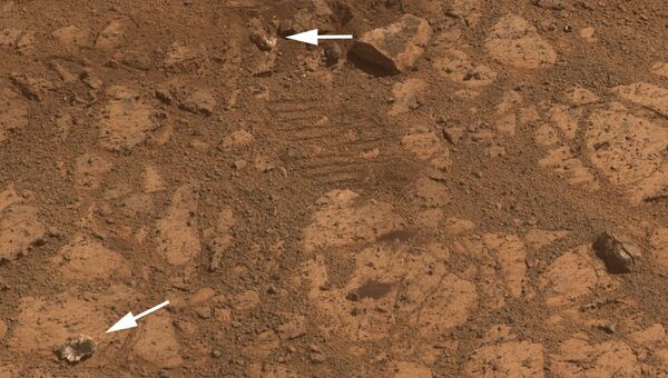 Снимок камеры марсохода Opportunity, на котором виден большой камень и отколовшийся от него кусочек Снимок камеры марсохода Opportunity, на котором виден большой камень и отколовшийся от него кусочек